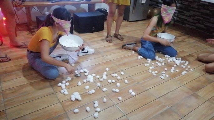 Scooping the Cotton Balls in the Overhead Bowl