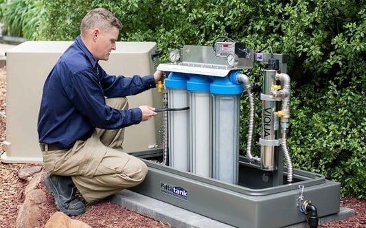 A man working on a water filtration system